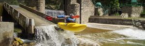 Kayak boofing off a dam